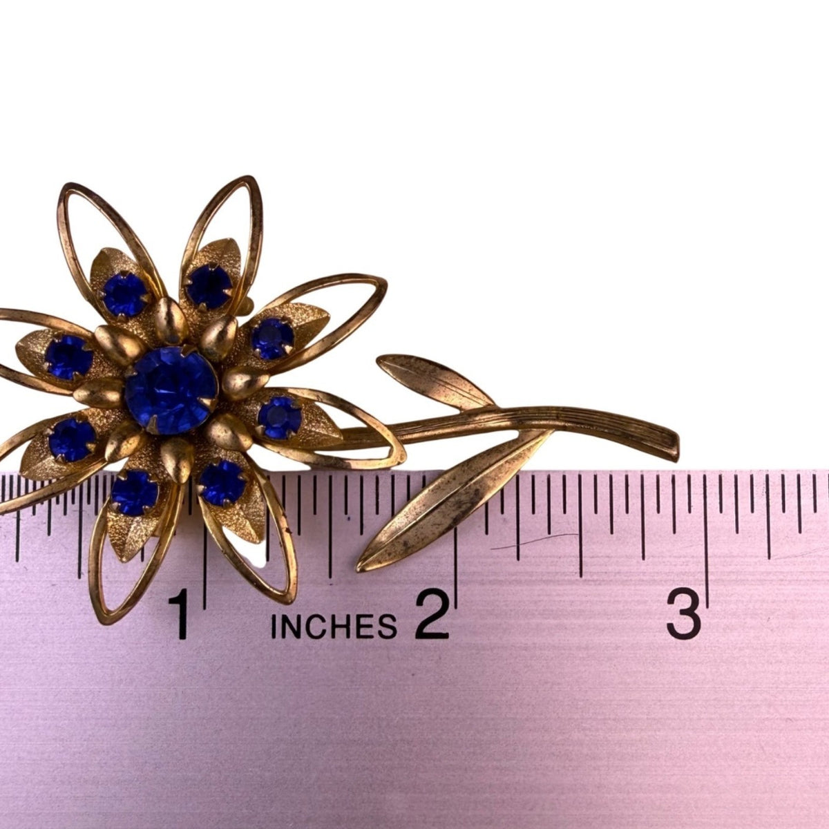Large Gold Tone Blue Rhinestone Flower Brooch Pin Vintage Pressed Metal Design