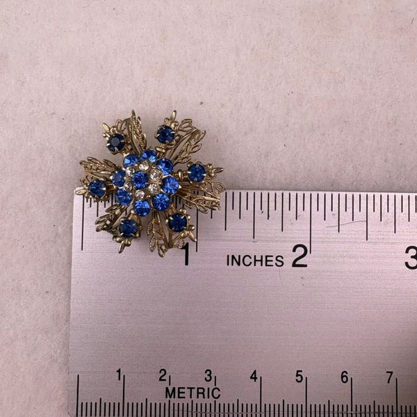 Vintage Unknown Blue Gold Tone Rhinestone Snowflake Brooch Resin Round Pin