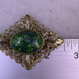 Vintage Unknown Gold-Tone Womens Oval Brooch Dragons Breath Glass Cabochon