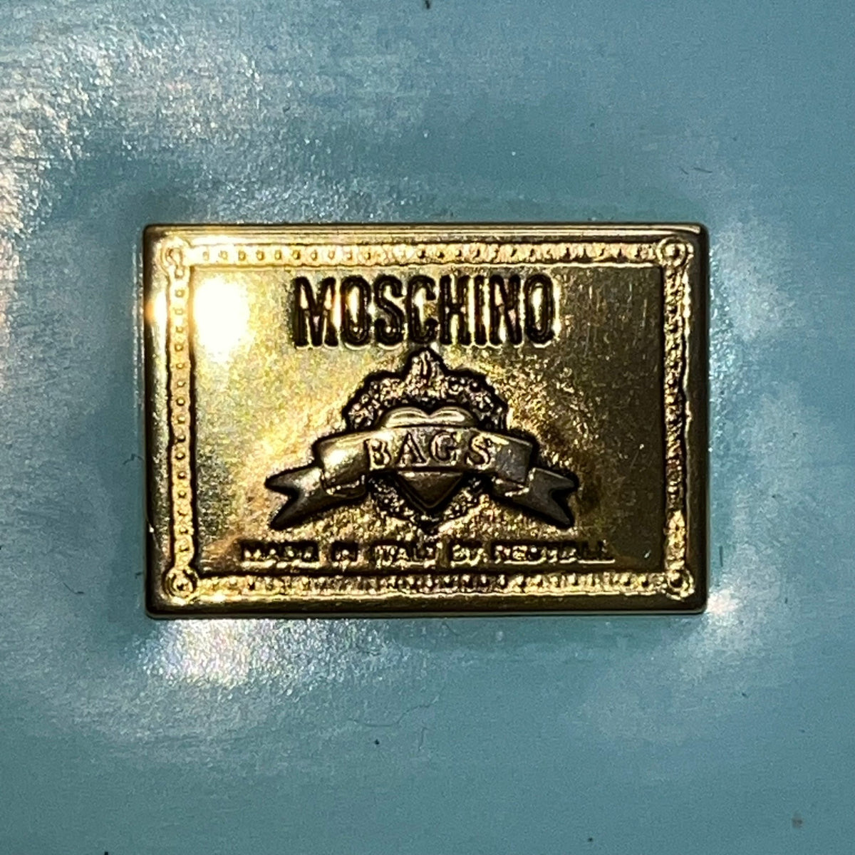 Moschino Women’s Light Blue Leather Gold Logo Hardware Structured Clutch Handbag