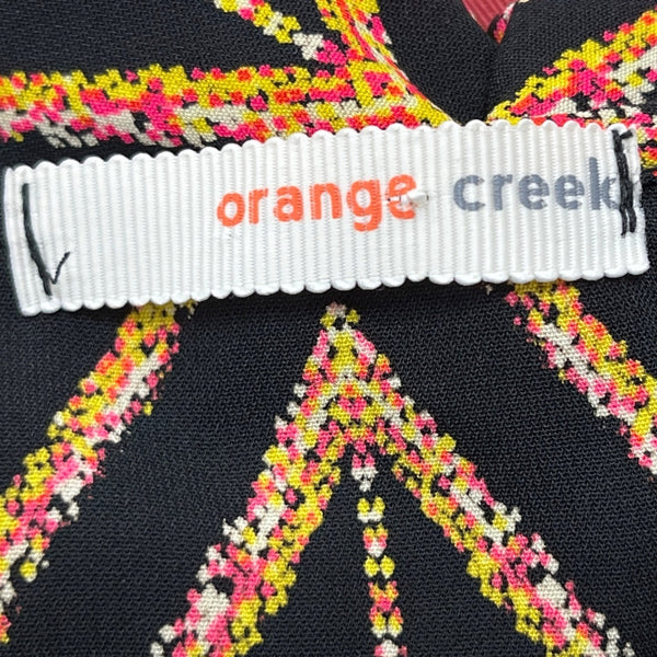Orange Creek Women's Black Sleeveless Romper With Orange Geometric Print