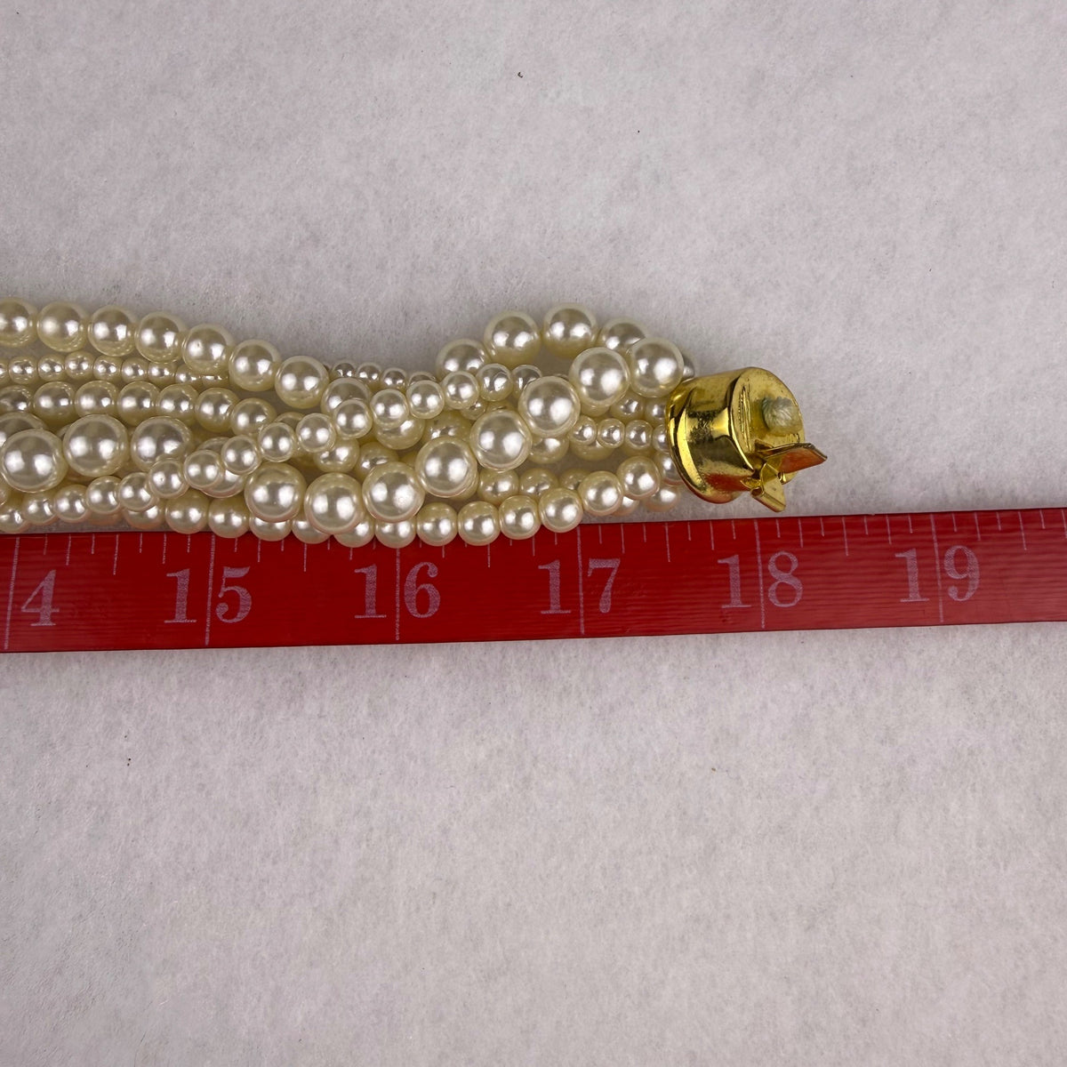Multi-Strand Faux Pearl Gold Tone Necklace With Center Rhinestone Accent Design