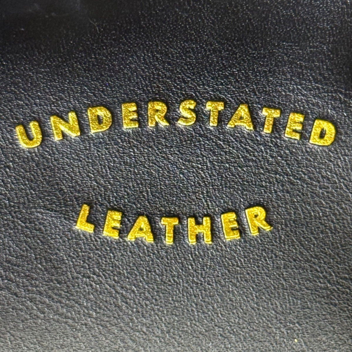 Understated Leather Women’s Black Leather With Tassel Detail & Gold Chain Clutch