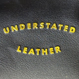 Understated Leather Women’s Black Leather With Tassel Detail & Gold Chain Clutch