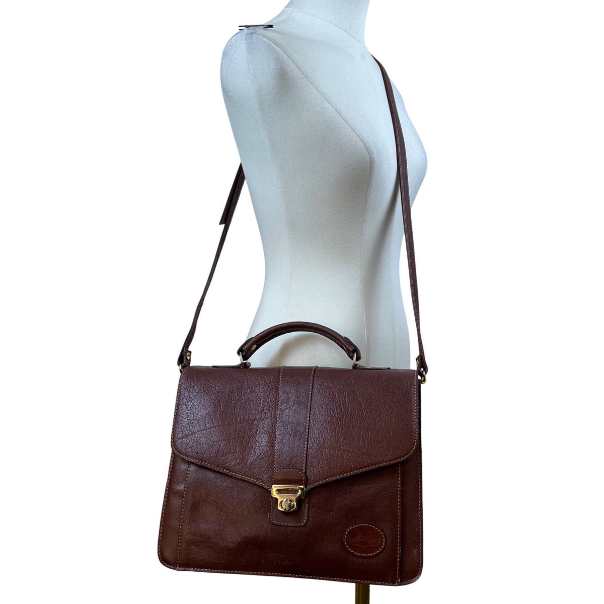 Milleni Women’s Brown Leather Lock Closure Adjustable Strap Crossbody Satchel